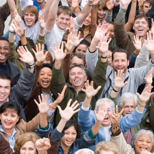 Large group of people waving at the camera